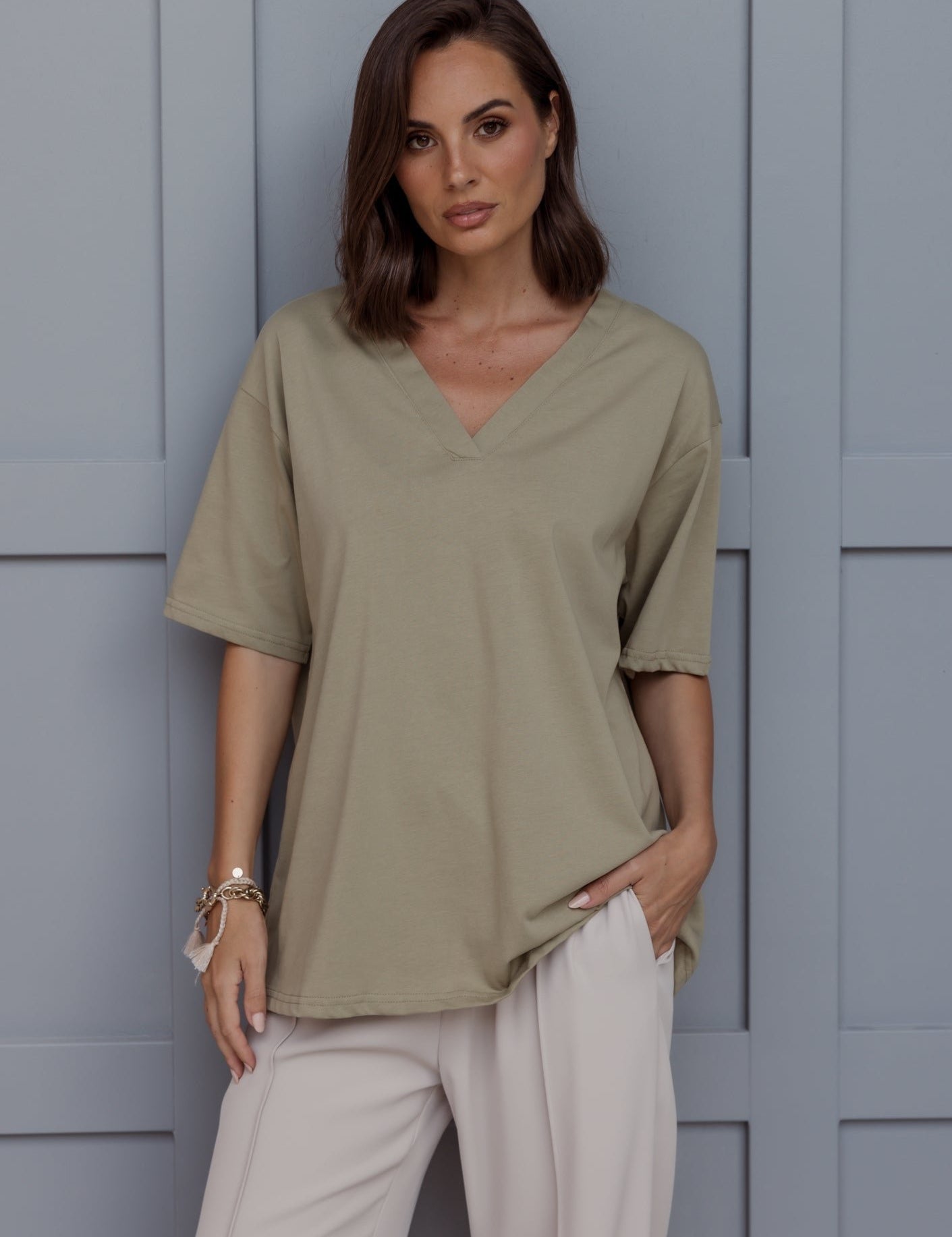 Woman wearing the NIX V-Neck T-Shirt in Green Taupe by ALEXANDRA