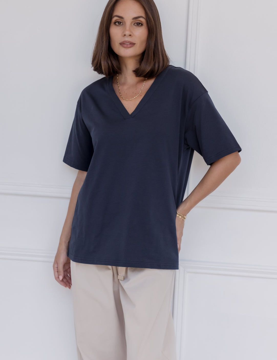 Woman wearing the NIX V-Neck T-Shirt in Navy by ALEXANDRA