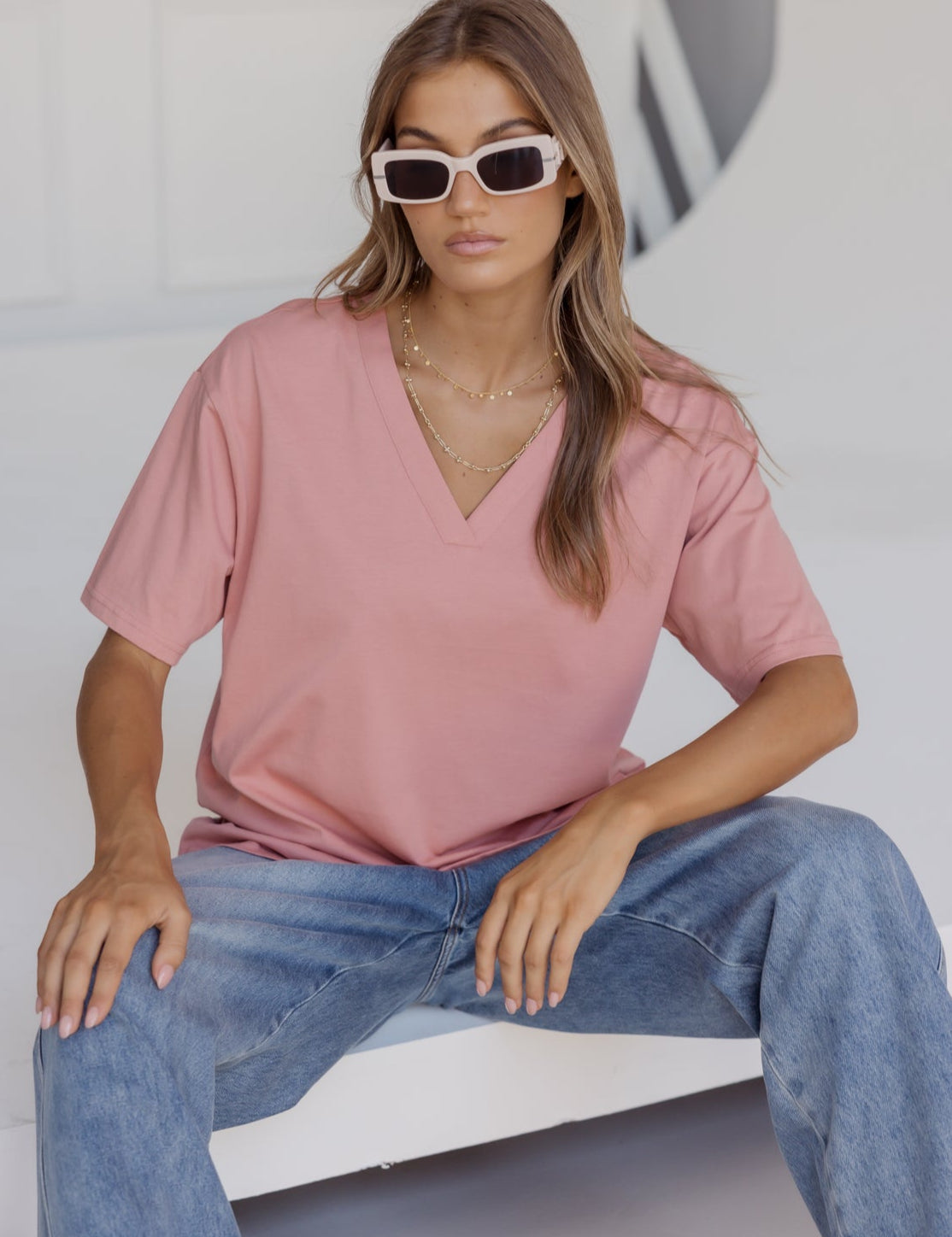 Woman wearing the NIX V-Neck T-Shirt in Dusty Rose by ALEXANDRA