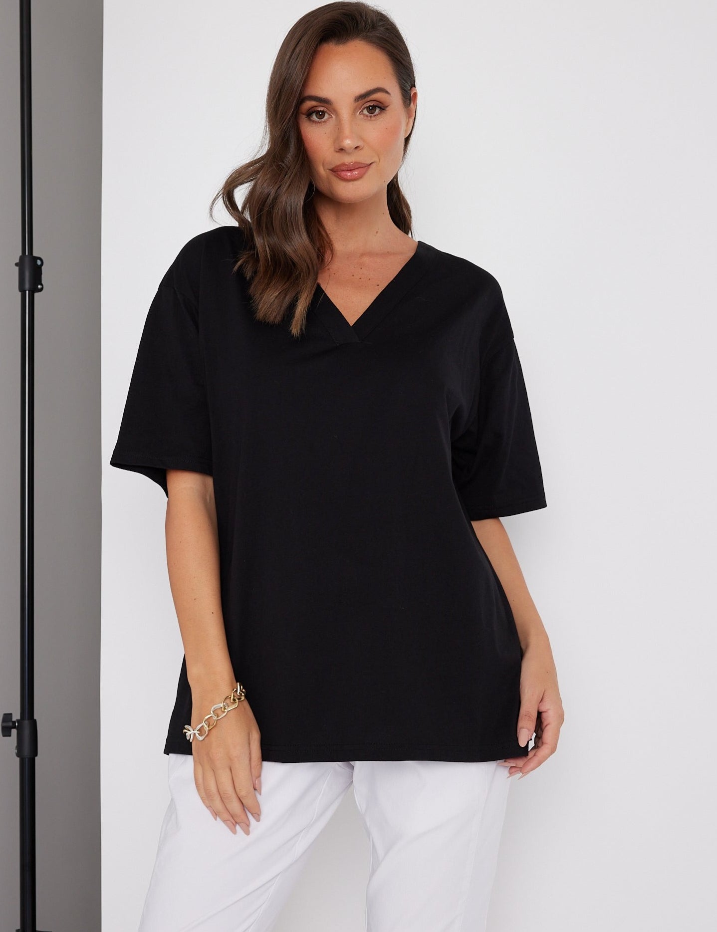 Woman wearing the NIX V-Neck T-Shirt in Black by ALEXANDRA