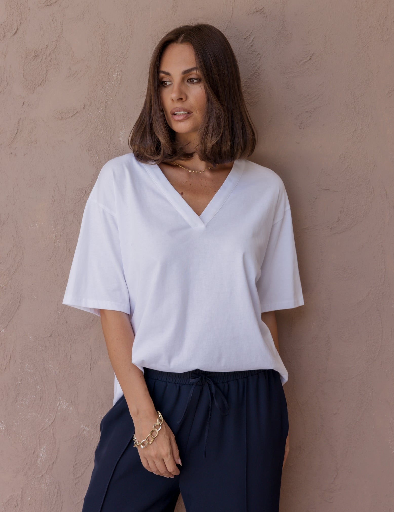 Woman wearing the NIX V-Neck T-Shirt in White by ALEXANDRA