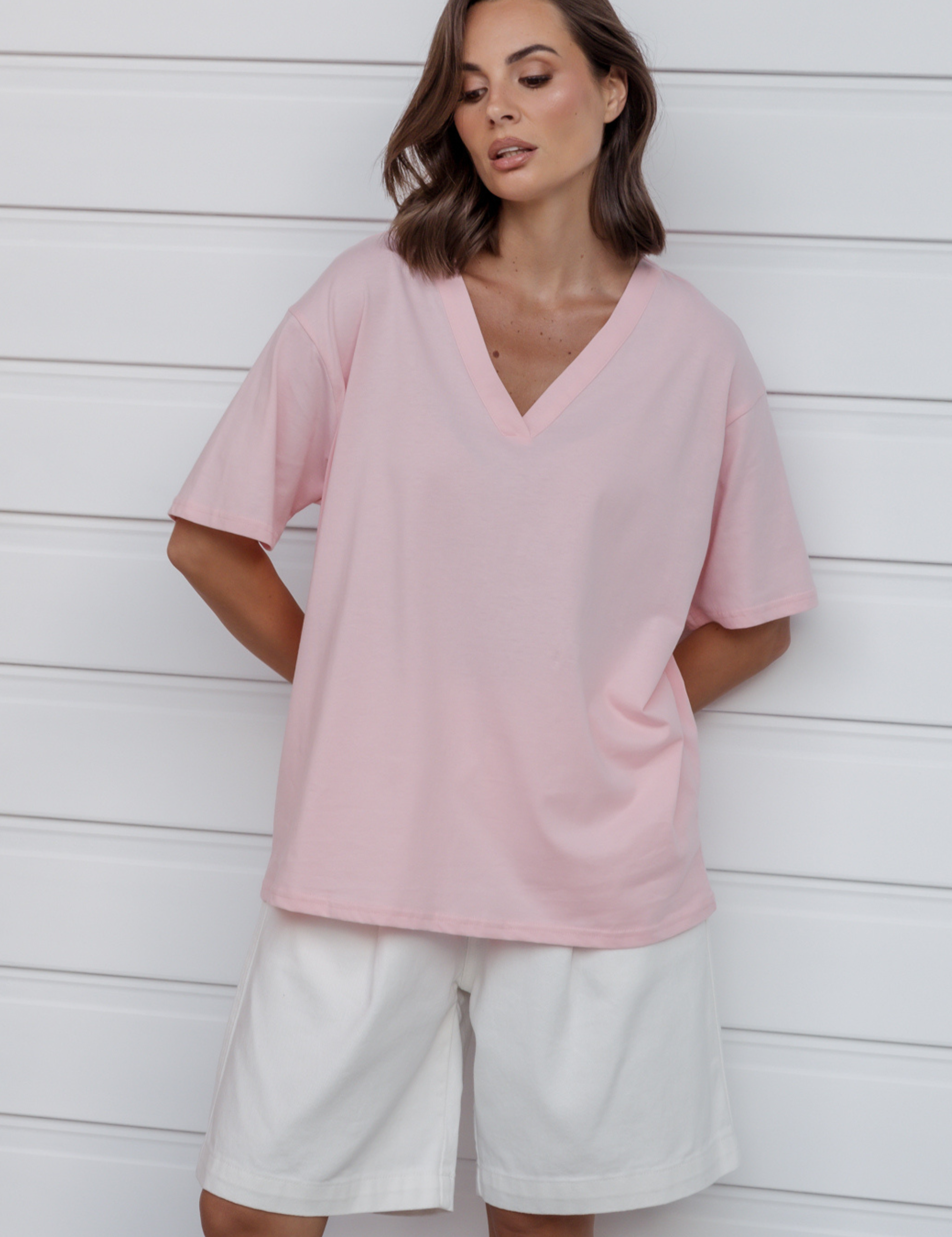 Woman wearing the NIX V-Neck T-Shirt in Pink by ALEXANDRA